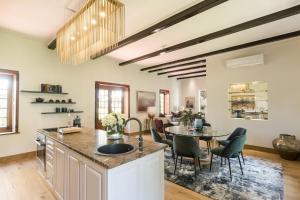 una cucina e una sala da pranzo con tavolo e sedie di Steenberg Hotel & Spa a Tokai
