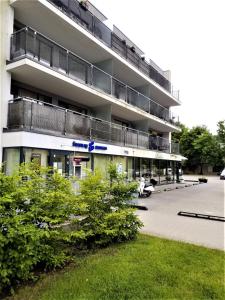 a large apartment building with balconies on the side of it at Beautiful Apartment in the heart of Birstonas in Birštonas