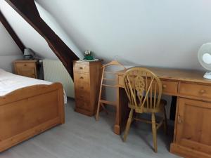 a bedroom with a desk and a bed and a chair at Maison( Clesanie ) in Serquigny