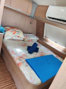 a bed with a book on it in an rv at Caravan In the Desert in Eilat