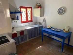 a kitchen with a blue table and a sink at Adamasseria in Collecorvino +40 photos