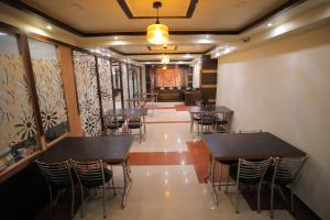 a row of tables and chairs in a restaurant at Hotel Marygold By The Golden Taj Group & Hotels in Agra