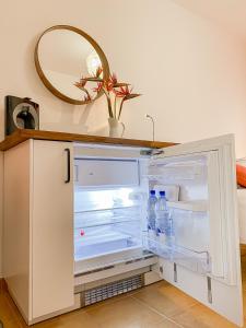 an open refrigerator with water bottles in it at Habitación Privada + Baño Privado en la vivienda in Corralejo