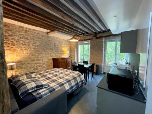 a bedroom with a bed and a table in a room at Thegreatflat in Paris