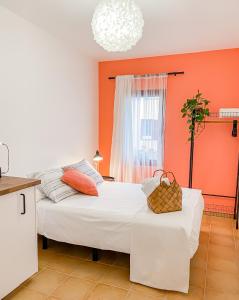 two beds in a room with orange walls at Habitación Privada + Baño Privado en la vivienda in Corralejo