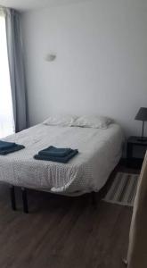 a bedroom with a bed with two towels on it at Hello Chloé in Vilamoura