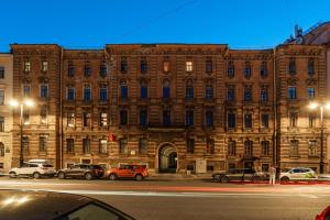 a large brick building with cars parked in front of it at Zen Hermitage in Saint Petersburg