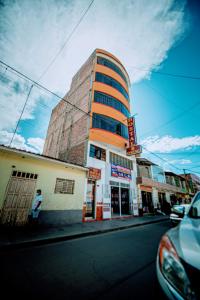 a tall building on a city street with at Hostal Spring II in Huánuco