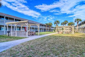 a row of apartment buildings with a park at Courtyard #113 in Port Aransas