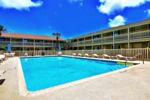 a large swimming pool in front of a hotel at Courtyard #206 in Port Aransas