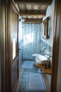 a bathroom with a sink and a toilet and a shower at Casa Terrarossa in Paceco