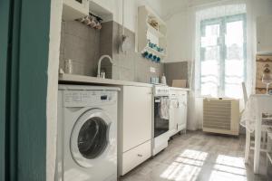 a laundry room with a washer and dryer at Vánkos Vendégház in Mindszent