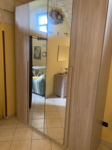 a mirror in a room with a bedroom at CASE VACANZA ZOE - SOLE in Serrano