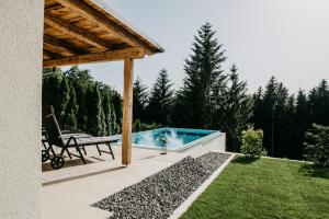 a backyard with a swimming pool and a pergola at Landhaus K07 in Allerheiligen bei Wildon
