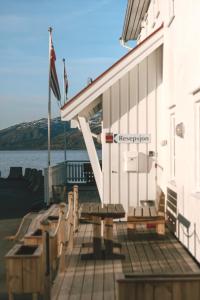 a dock with benches next to a building at Lødingen Brygge in Lødingen