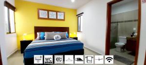 a bedroom with a white bed and a blue wall at Suite Isla Mujeres in Isla Mujeres