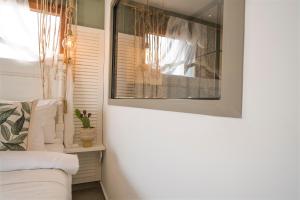a living room with a couch and a window at Liman Hotel Gümüslük - Adult Only in Bodrum City