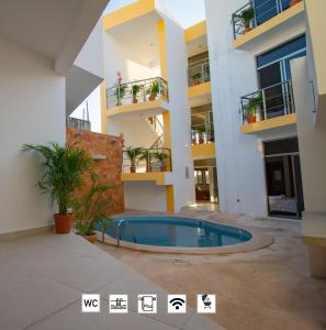 a large swimming pool in a large building at Suite Isla Mujeres in Isla Mujeres