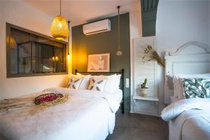 a bedroom with two beds and a window at Liman Hotel Gümüslük - Adult Only in Bodrum City