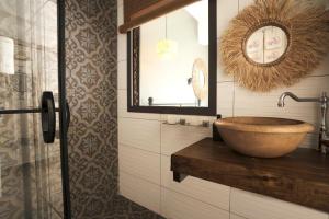 a bathroom with a wooden sink and a mirror at Liman Hotel Gümüslük - Adult Only in Bodrum City