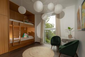 a small room with a bed and a desk and a window at Senhora da Rosa, Tradition & Nature Hotel in Ponta Delgada