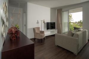 a living room with a couch and a table at Senhora da Rosa, Tradition & Nature Hotel in Ponta Delgada