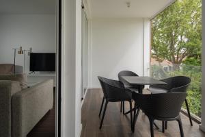 a dining room with a table and chairs and a window at Senhora da Rosa, Tradition & Nature Hotel in Ponta Delgada