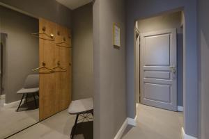 a hallway with a door and a stool and a chair at KH Opera Apartments in Vienna