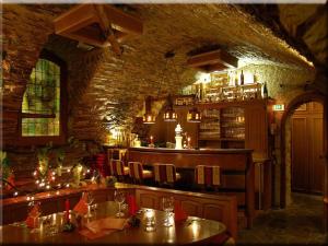 a restaurant with a bar with a stone wall at Hotel Graf Rolshausen in Monschau