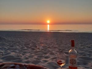 Una botella de vino y una copa en la playa en Mazowiecka Park, en Kołobrzeg