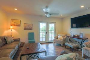 a living room with a couch and chairs and a tv at Carolina Breezes West in Isle of Palms