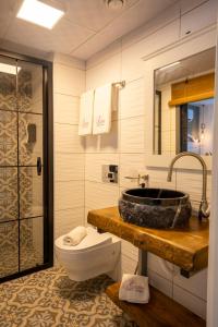 a bathroom with a sink and a toilet at Liman Hotel Gümüslük - Adult Only in Bodrum City