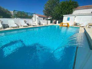 a swimming pool with a slide in the middle at Apartments King - City center in Novalja