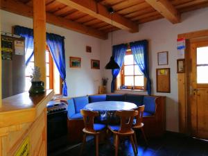 a kitchen with a table and chairs in a room at Julianna Nyaraló in Csopak
