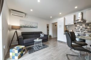 a living room with a couch and a table at Apartments Aldo in Cavtat +16 photos