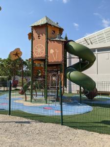 a playground with a slide in a park at Mobil home Stéfie in Vias