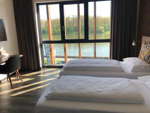 Postel nebo postele na pokoji v ubytování Hotel Donauhof Mauthausen