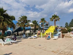 a water park with a slide and a water slide at Mobil home Stéfie in Vias