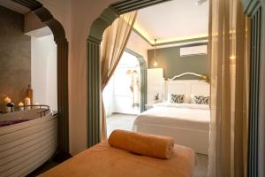 a bedroom with a bed and a large window at Liman Hotel Gümüslük - Adult Only in Bodrum City