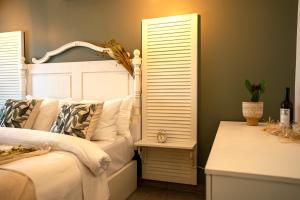 a bedroom with a white bed and a window at Liman Hotel Gümüslük - Adult Only in Bodrum City
