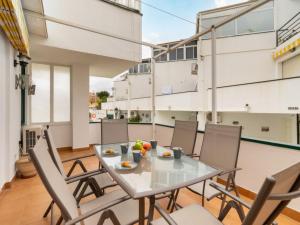 een tafel en stoelen op een balkon met een maaltijd erop bij Oasis Torremolinos in Torremolinos