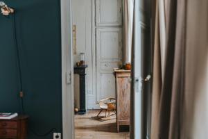 a hallway with a room with a table and a chair at Maison Séraphine - Guest house - Bed and Breakfast in Laon +89 photos