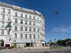 un grande edificio bianco all'angolo di una strada di KH Opera Apartments a Vienna