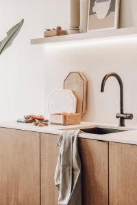 a kitchen with a sink and a counter top at ZETU The Dunes in Knokke-Heist