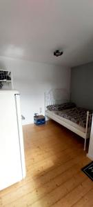 a bedroom with a bed and a wooden floor at Apart of "MET" in Mellrichstadt