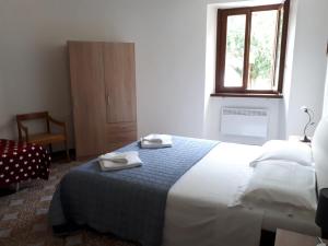 a bedroom with a bed with two towels on it at B&B appartamenti chez Patty in Castel San Pietro