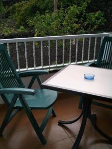 two chairs and a table on a balcony at Hotel Ida Inés in Frontera