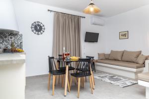 a living room with a table and chairs and a couch at Dolce Vita appartments in Naxos Chora