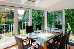 a dining room with a table and chairs at Abramówka - dom z jacuzzi in Polańczyk +15 photos