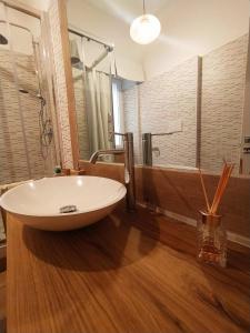 a bathroom with a large white sink and a shower at Dimora Ninfee in Rome